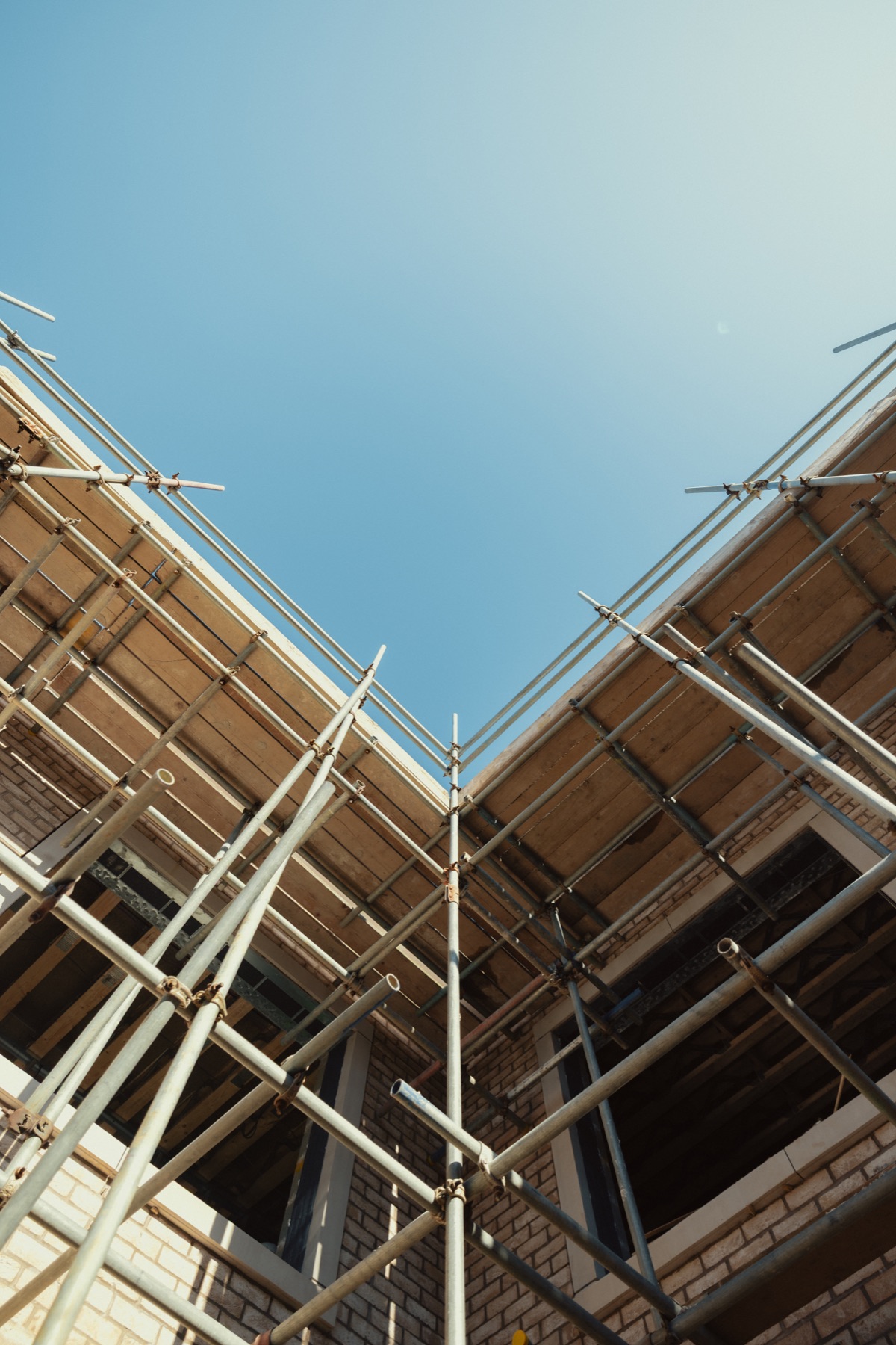 Looking up between the brick elevations and scaffolding at Park View during construction