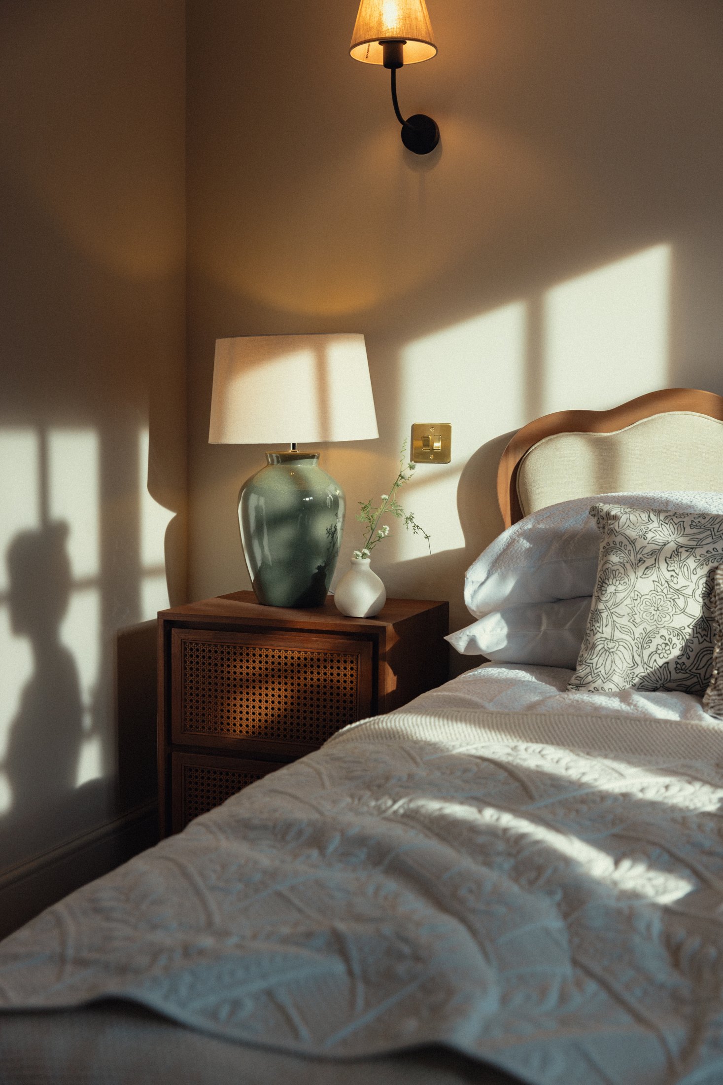 Sunlight tracing the bedroom walls.