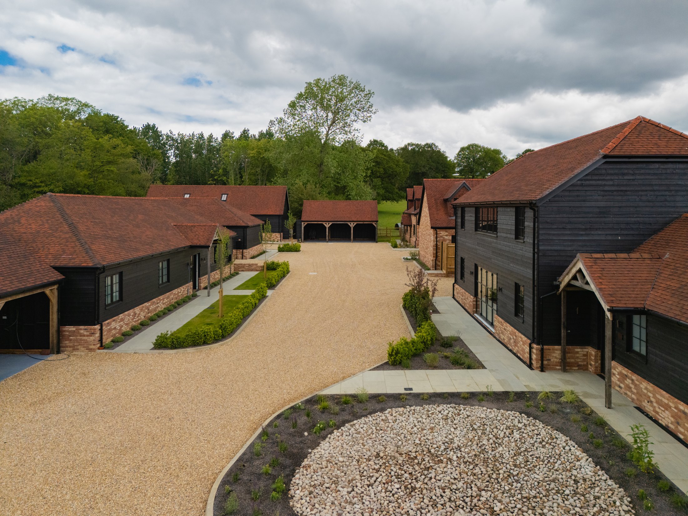 Dark timber-clad homes lining the landscaped courtyard at Meadow View